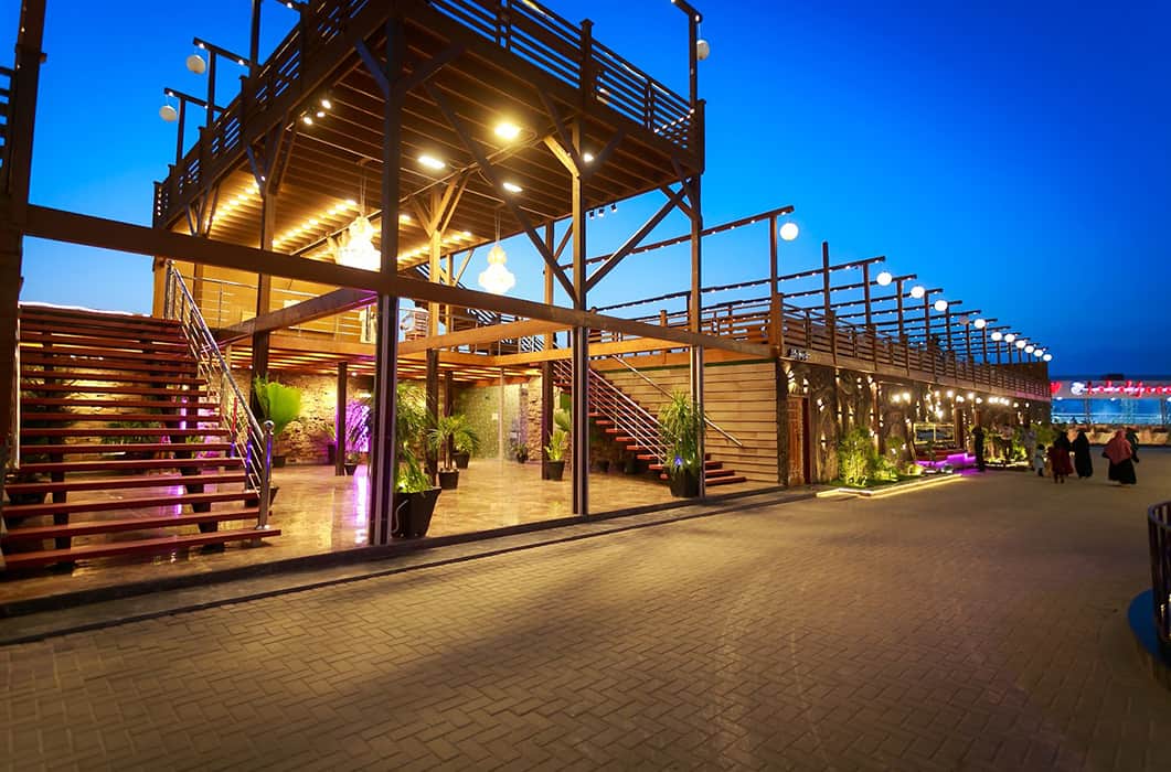 Wooden two-level terrace with warm string lights