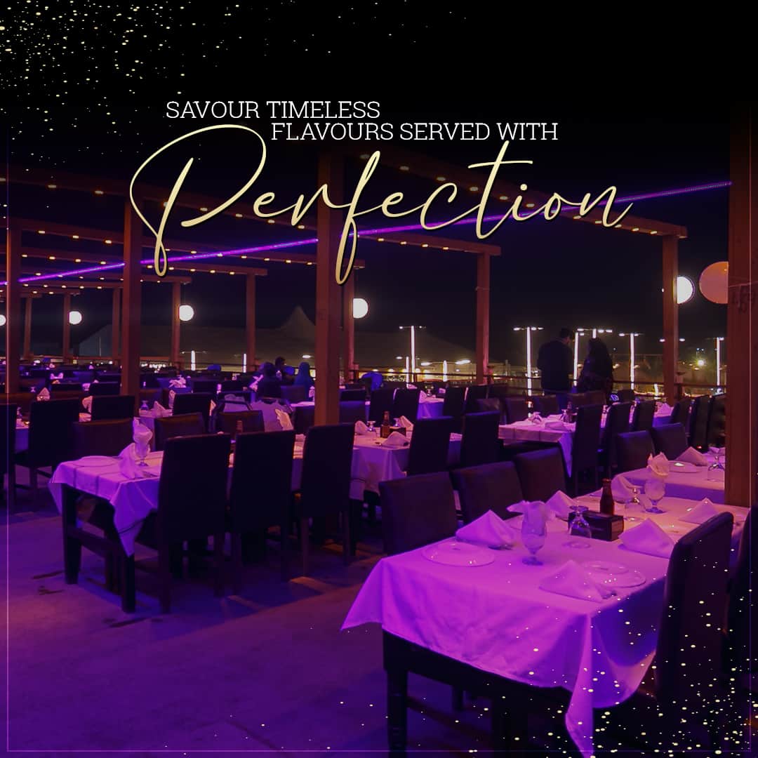 Tables glowing violet under night lights